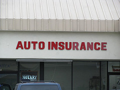 office with red auto insurance sign
