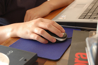 holding computer mouse comparing rates online