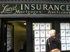 Women standing next to insurance brokerage shop