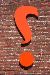 orange question mark on wall